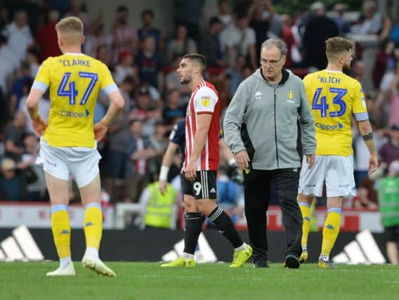 Leeds United head coach Marcelo Bielsa greets his players at Brentford following the final whistle.