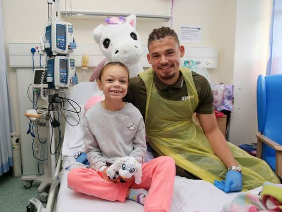 Leeds United star Kalvin Phillips meets a young patient during a visit to Leeds General Infirmary.