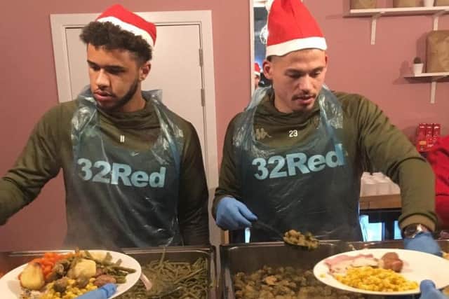 Kalvin Phillips and Leeds United team-mate Tyler Roberts do their bit at a festive dinner for the homeless.