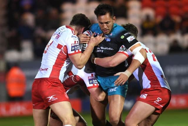 Nathaniel Peteru is tackled by the Hull KR defence.