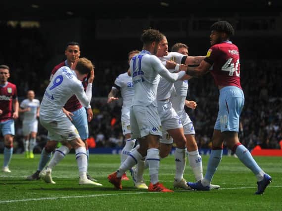 Aston Villa players confront Mateusz Klich following the controversial goal.