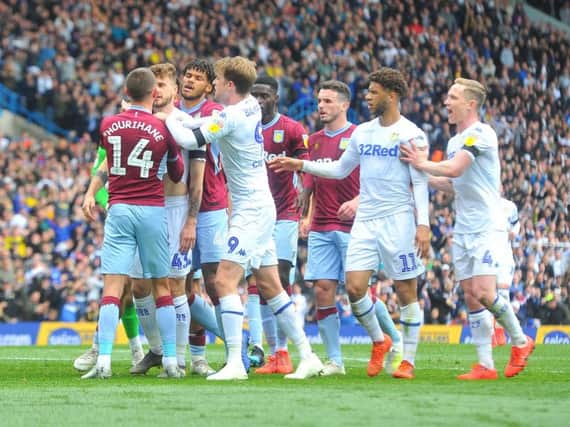 Leeds United and Aston Villa players clash following Mateusz Klich's opening goal.