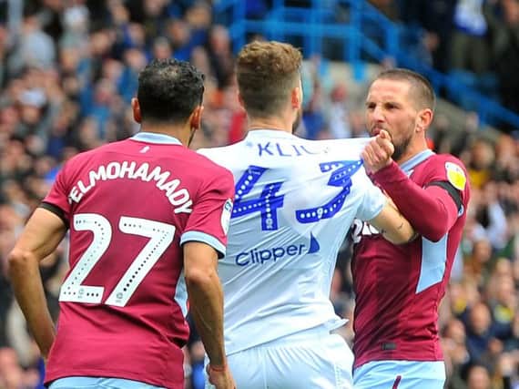 Leeds United midfielder Mateusz Klich clashes with Aston Villa players after opening goal at Elland Road.