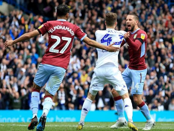 Leeds United's Mateusz Klich confronted by Aston Villa players following opening goal at Elland Road.