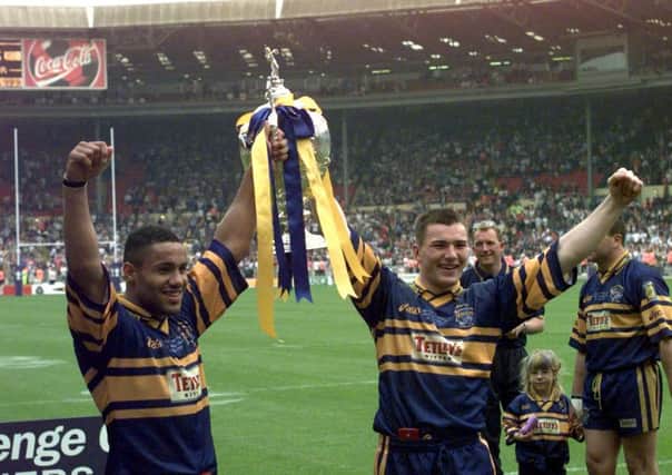 Man of the match Leroy Rivett and Iestyn Harris hold the Challenge Cup aloft after Leeds Rhinos' 1999 final victory over London Broncos.