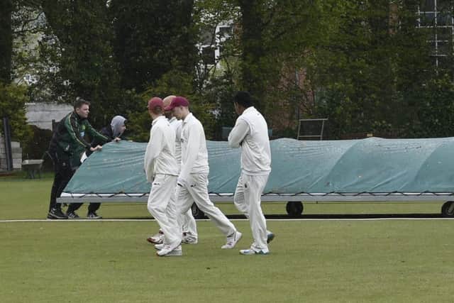 A familier first-day-of-the-season scene as the players head for cover and the covers come on at New Farnley. PIC: Steve Riding