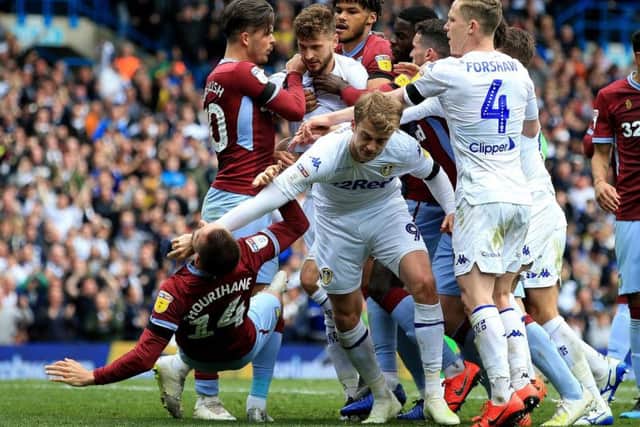 Patrick Bamford and Conor Hourihane clash during Leeds United's draw with Aston Villa.