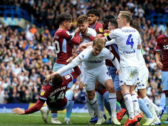 Patrick Bamford and Conor Hourihane clash during Leeds United's draw with Aston Villa.
