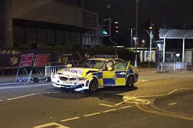 A police car was damaged in a crash involving a MIni Cooper outside Headingley Stadium