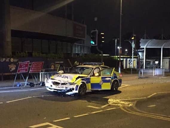 A police car was damaged in a crash involving a MIni Cooper outside Headingley Stadium