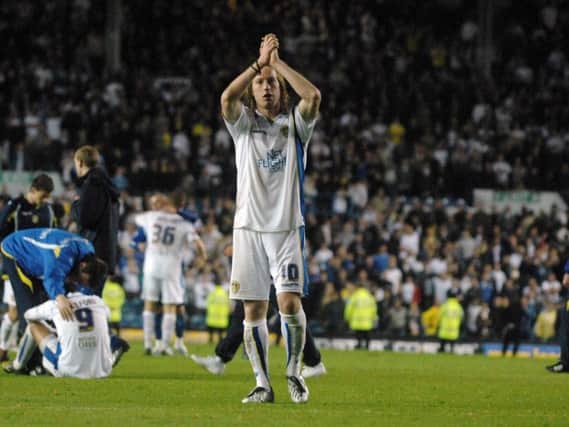 Luciano Becchio applauds the Elland Road crowd, with Simon Grayson and Jermaine Beckford in the background, after defeat to Millwall in the 2009 League One play-off semi-finals.