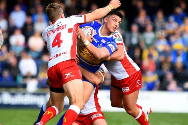 Owen Trout is tackled by Jimmy Keinhorst and Kane Linnett of Hull Kingston Rovers.