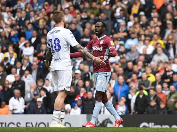 Pontus Jansson and Albert Adomah clash after Leeds United let Aston Villa score a walk-in goal at Elland Road.