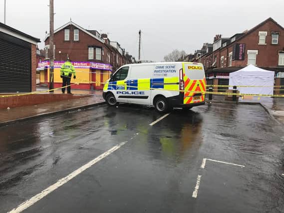 Police at the scene of a stabbing on Harehills Road in Leeds