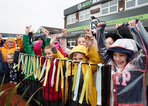 Children from St Josephs school, Castleford celebrate the arrival of the Tour de Yorkshire