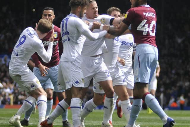 Leeds United's players clash with Aston Villa at Elland Road.