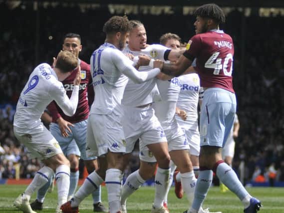Leeds United's players clash with Aston Villa at Elland Road.