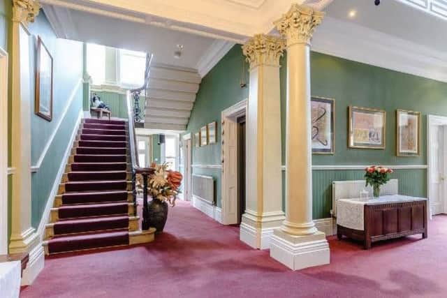 On arrival, the grand portico entrance with original door opens up into the spectacular entrance hall with galleried landing above.