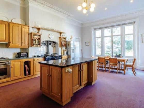 It features dual aspect windows, magnificent ornate coving and ceiling rose features a range of solid wooden units, a central island, granite work surfaces and matching Welsh dresser.