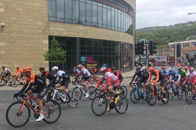 The Tour de Yorkshire riders snake past the Broad Street Plaza in Halifax.