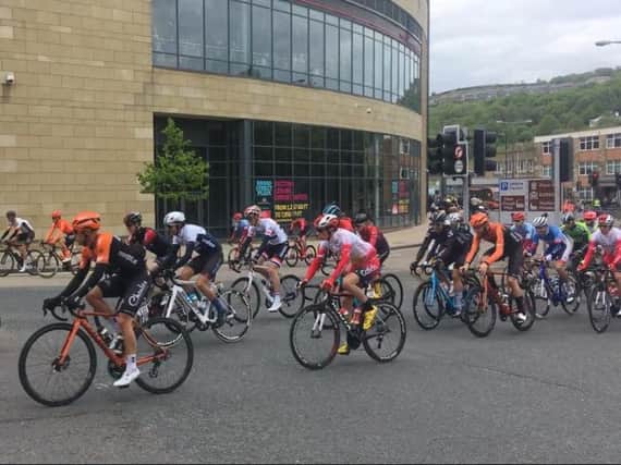The Tour de Yorkshire riders snake past the Broad Street Plaza in Halifax.