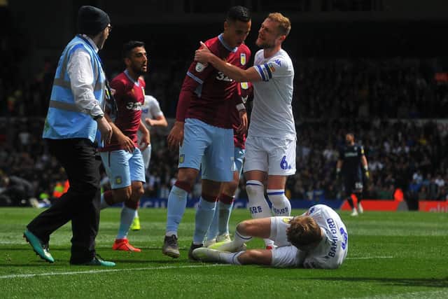 Patrick Bamford lies on the ground after a clash with Aston Villa's Anwar El Ghazi. The Leeds United striker was given a two-match ban for simulation.