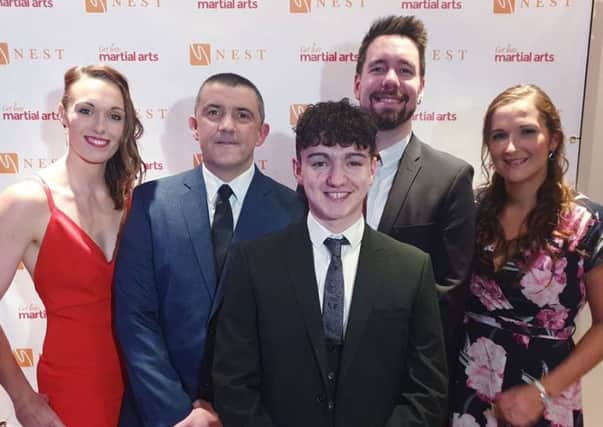 Charlotte Watson, right, pictured at the NEST Gala Awards with coaching staff and students from the British Military Martial Arts group.