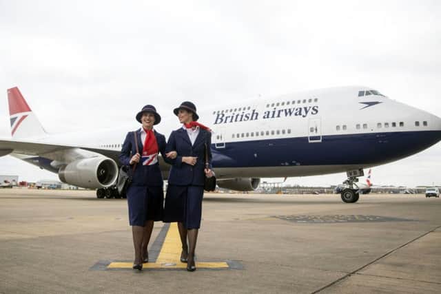 Ambassadors Elysa Marsden (left) and Olivia Welch in front of a Boeing 747 in British Airways Negus livery, part of British Airways' centenary fleet, arriving at London's Heathrow Airport. PRESS ASSOCIATION Photo. Photo: Steve Parsons/PA Wire