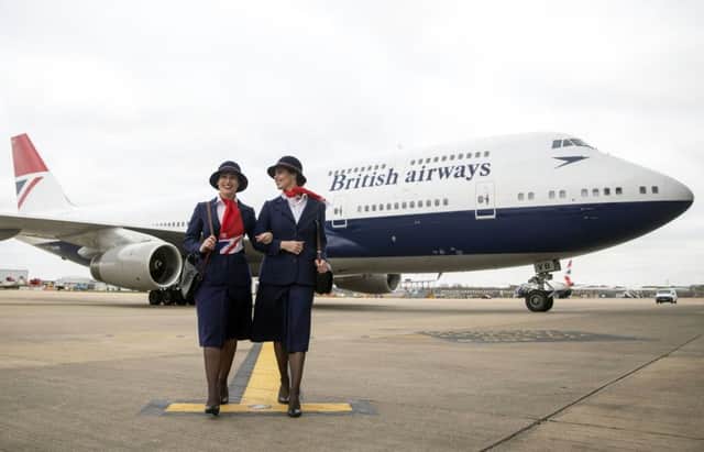 Ambassadors Elysa Marsden (left) and Olivia Welch in front of a Boeing 747 in British Airways Negus livery, part of British Airways' centenary fleet, arriving at London's Heathrow Airport. PRESS ASSOCIATION Photo. Photo: Steve Parsons/PA Wire