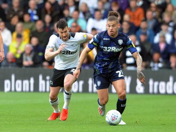 Leeds United's Kalvin Phillips busts away from Derby's David Nugent. Picture by Tony Johnson.