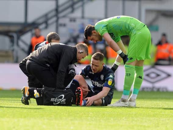 Leeds United's Adam Forshaw picks up an injury during the first half at Pride Park.