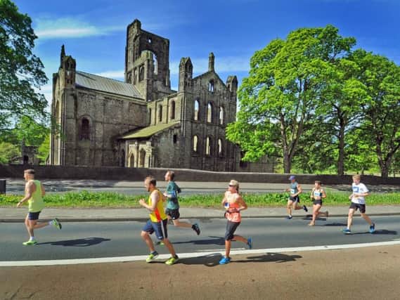 Leeds Half Marathon runners pass Kirkstall Abbey during the 2018 race