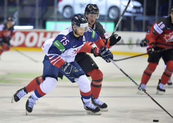 Robert Dowd battles for posession against Canada at the Steel Arena in Kosice. Picture: Dean Woolley.