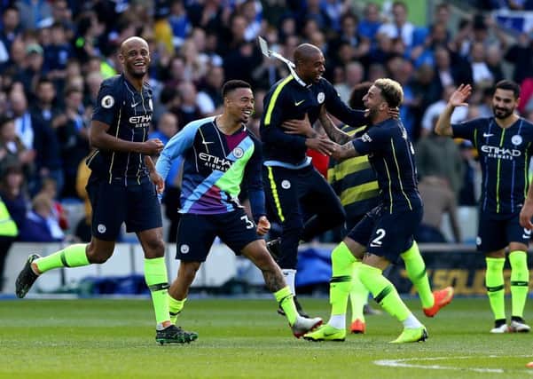 Manchester City's Vincent Kompany (left) celebrates winning the Premier League title at the AMEX Stadium. Picture: Gareth Fuller/PA
