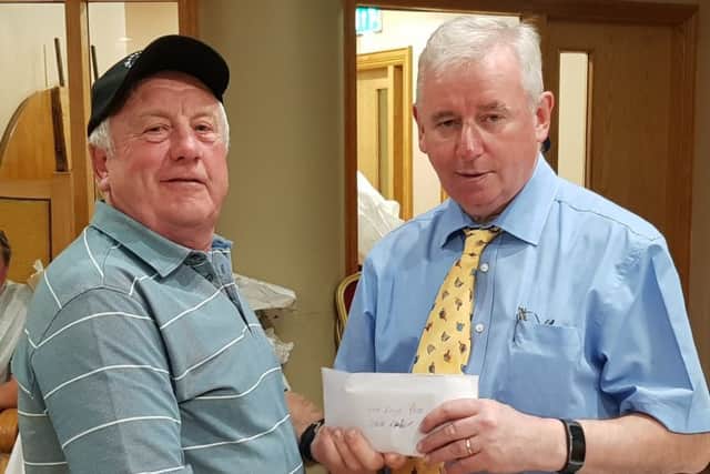 Irish festival veteran, Steve Raper of Harehills, receiving prize money from sponsor Joe Mahon after another successful week on the banks of Fermanaghs River Erne.