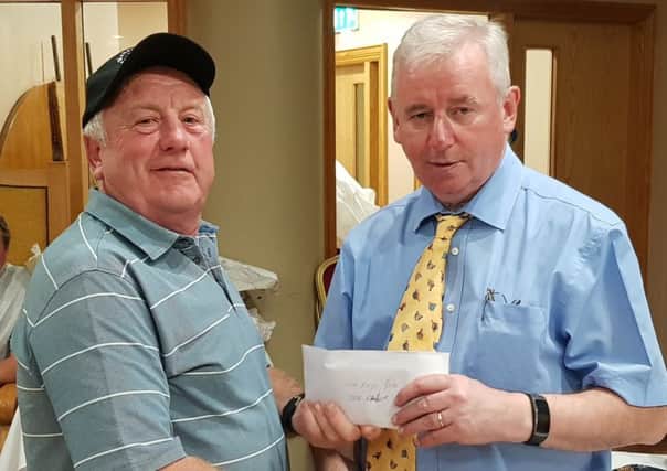 Irish festival veteran, Steve Raper of Harehills, receiving prize money from sponsor Joe Mahon after another successful week on the banks of Fermanaghs River Erne.