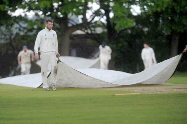 The covers come on again and play is ended for the day at Pudsey Congs, who had had Wakefield St Michael's on the ropes. PIC: Steve Riding