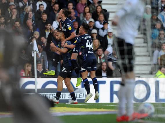 Leeds United celebrate Kemar Roofe's opening goal at Pride Park against Derby County.