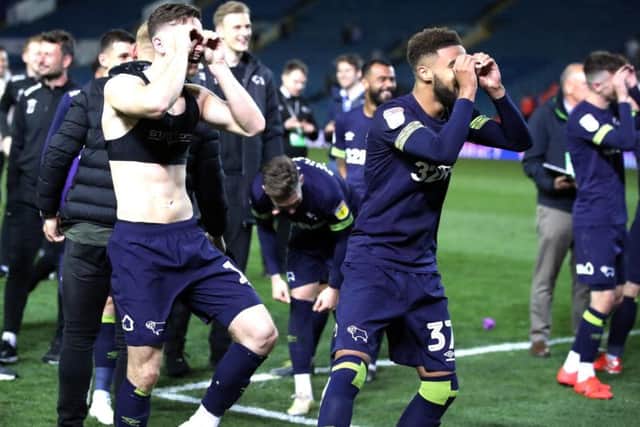 Derby County players taunt Leeds United fans following the match.