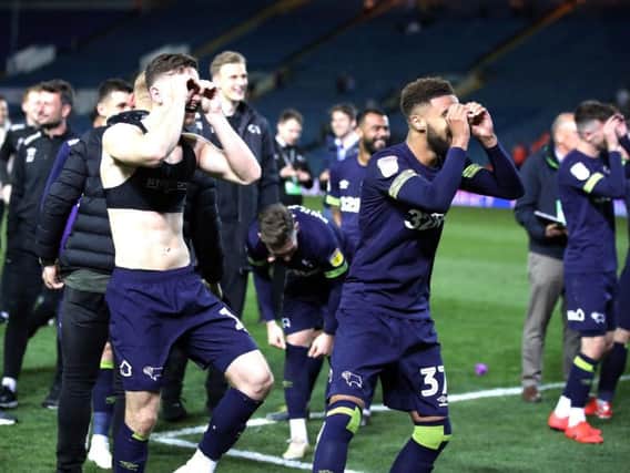 Derby County players taunt Leeds United fans following the match.