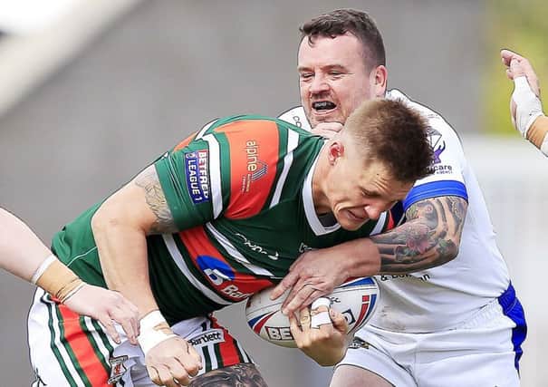 Hunslet's Dan Hawksworth is  tackled by Workington's Sean Penkywiecz during the last meeting between the sides.