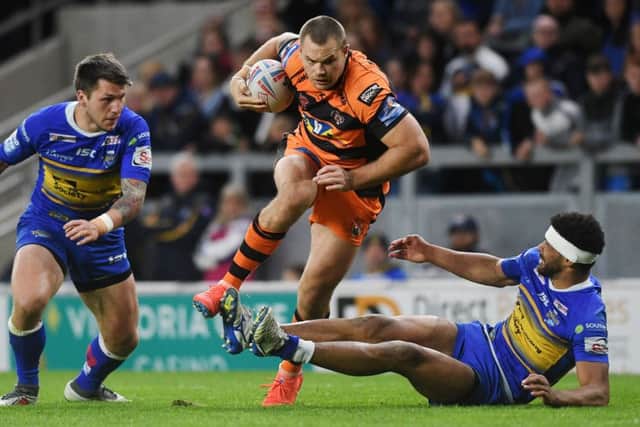 Rhinos' Kallum Watkins can't stop Tigers' Cheyse Blair. Picture Jonathan Gawthorpe