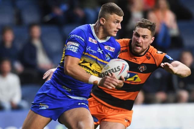 Rhinos' Ash Handley looks to get away from Tigers' James Clare.
