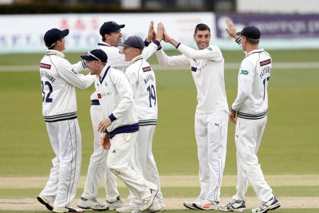 Duanne Olivier (2nd R) of Yorkshire is congratulated by team mates after he took the wicket of Fred Klaassen.