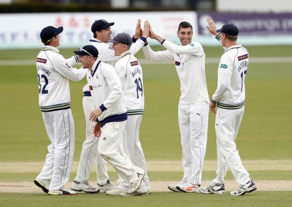 Duanne Olivier (2nd R) of Yorkshire is congratulated by team mates after he took the wicket of Fred Klaassen.