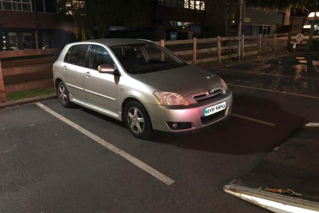 The silver Toyota police boxed in inside the drive-through car park