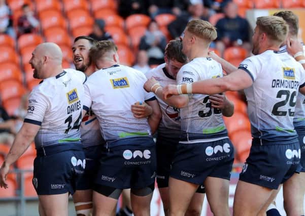 Featherstone Rovers celebrate after Tom Holmes scored against York City Knights on Sunday.