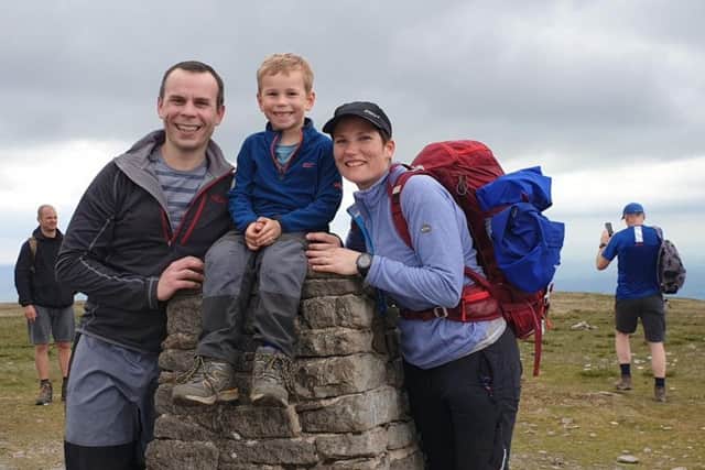 Noah Thomson, six, reaches the summit of Whernside with parents Rob and Helen