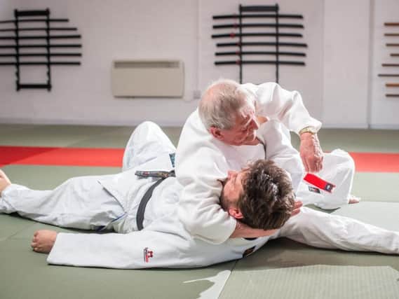 Bill demonstrating judo moves on an opponent. PIC: SWNS