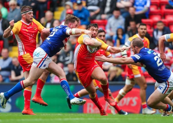 Wakefield's George King, right, and Danny Kirmond tackle Catalans Dragons' Matty Smith.